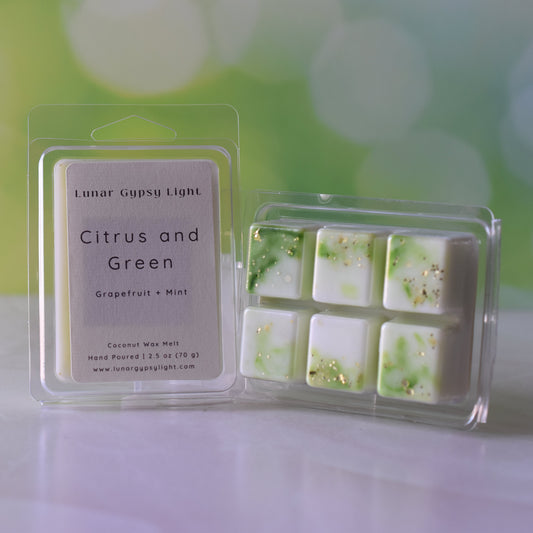 Packaged wax melt that says Citrus and Green on a shell like surface and blurred green and yellow background