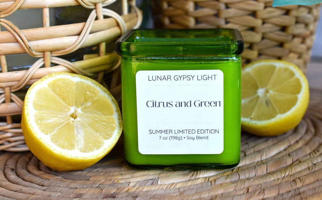 Candle in green glass jar labeled citrus and Green with lemons on either side