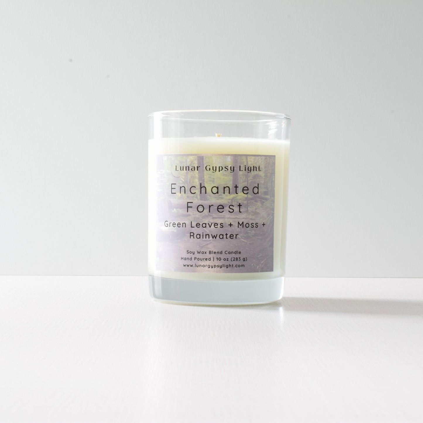Candle labeled 'Enchanted Forest' with a white background