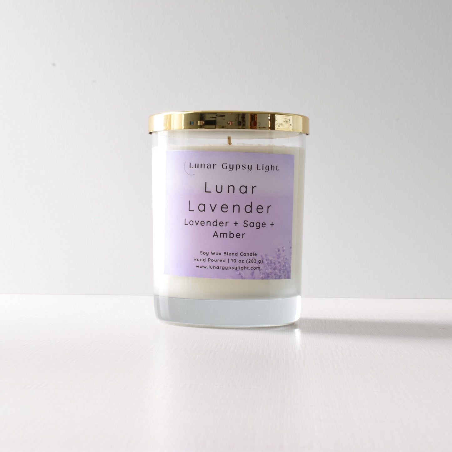 Candle with a purple label "Lunar Lavender" on a white background