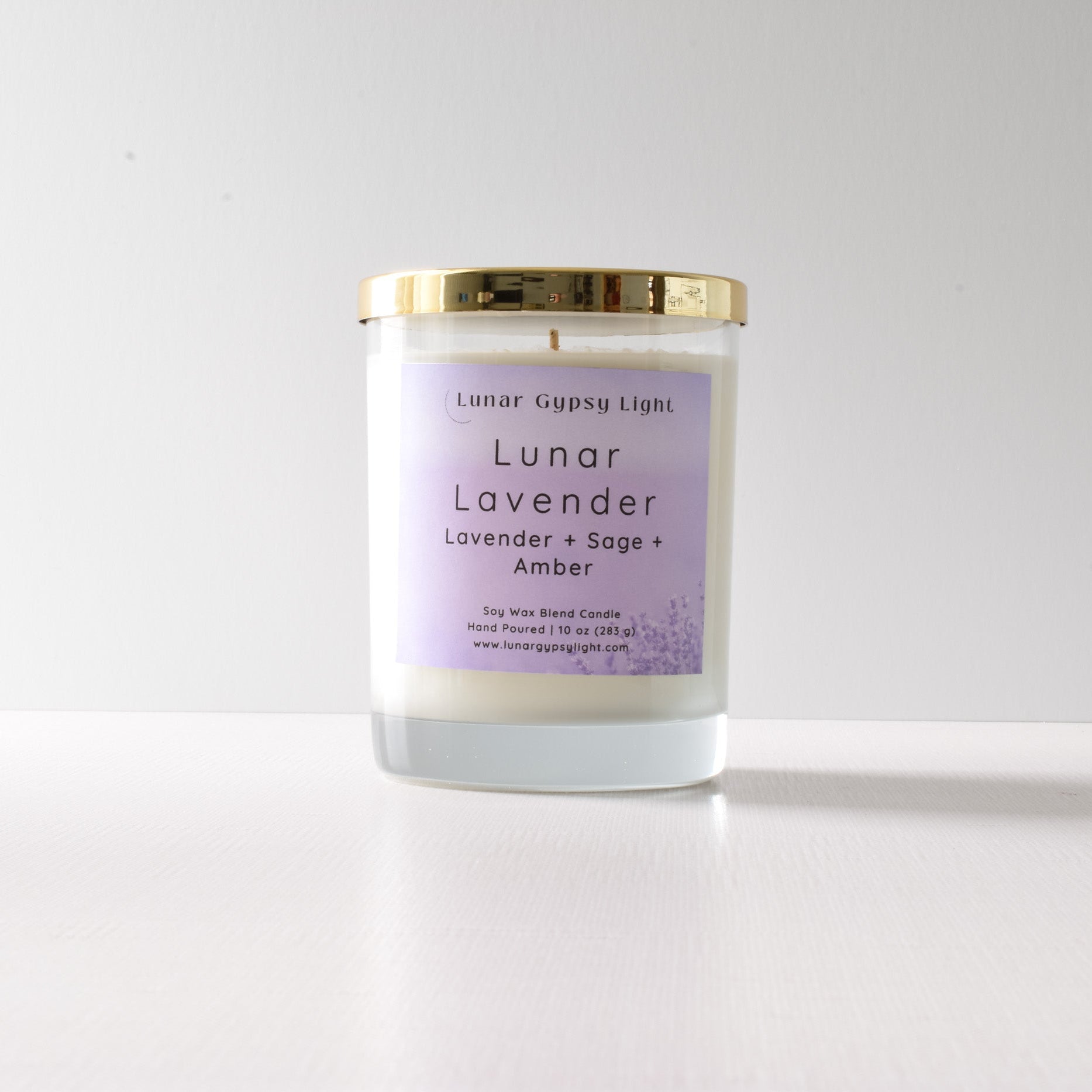 Candle with a purple label "Lunar Lavender" on a white background