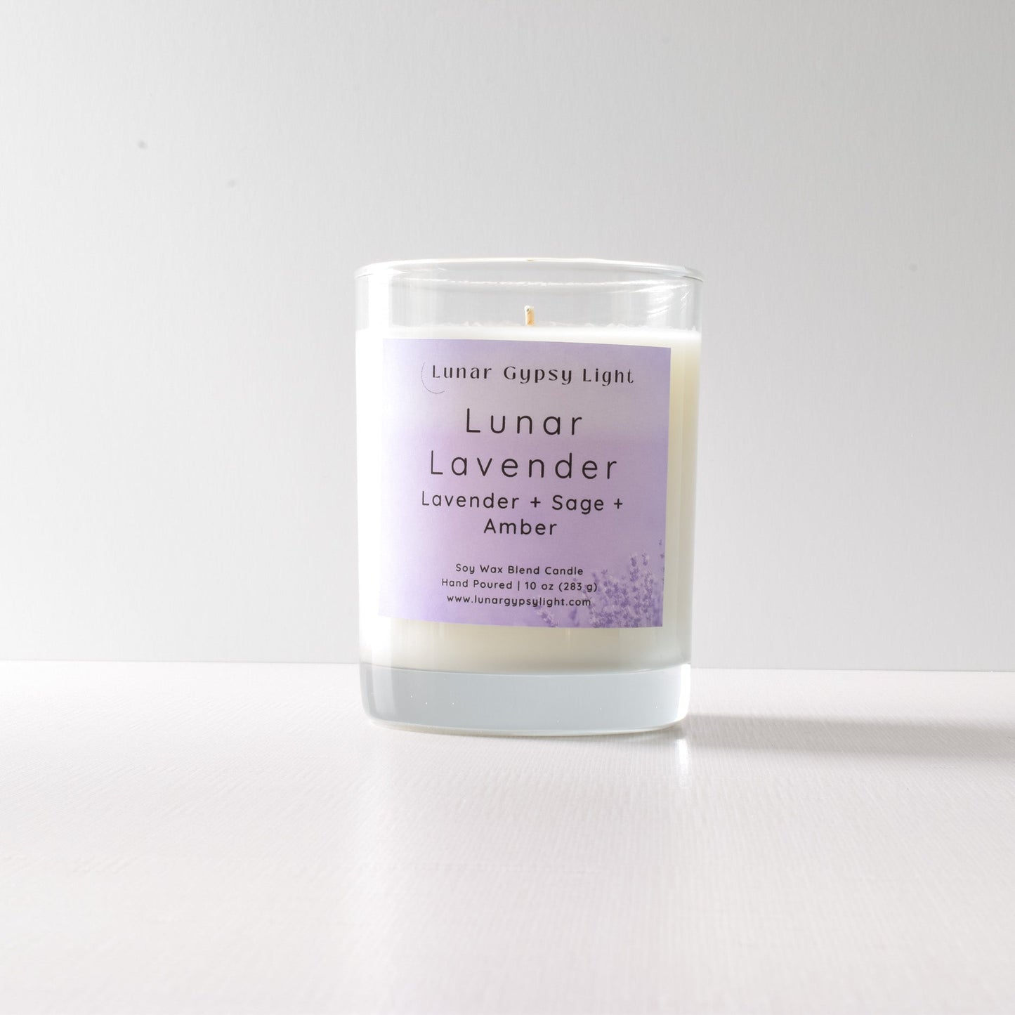 Candle with a purple label "Lunar Lavender" on a white background