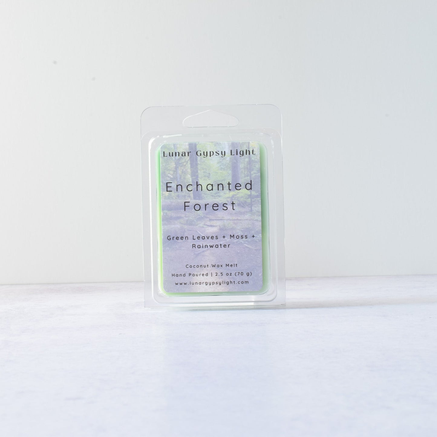 Wax melt packaging labeled 'Enchanted Forest' on a white background