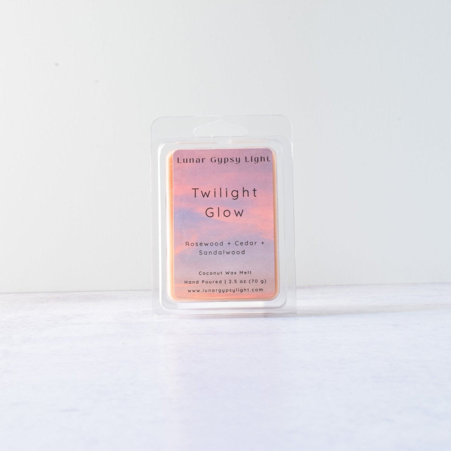 Wax melt with product packaging with 'Twilight Glow' on a white background