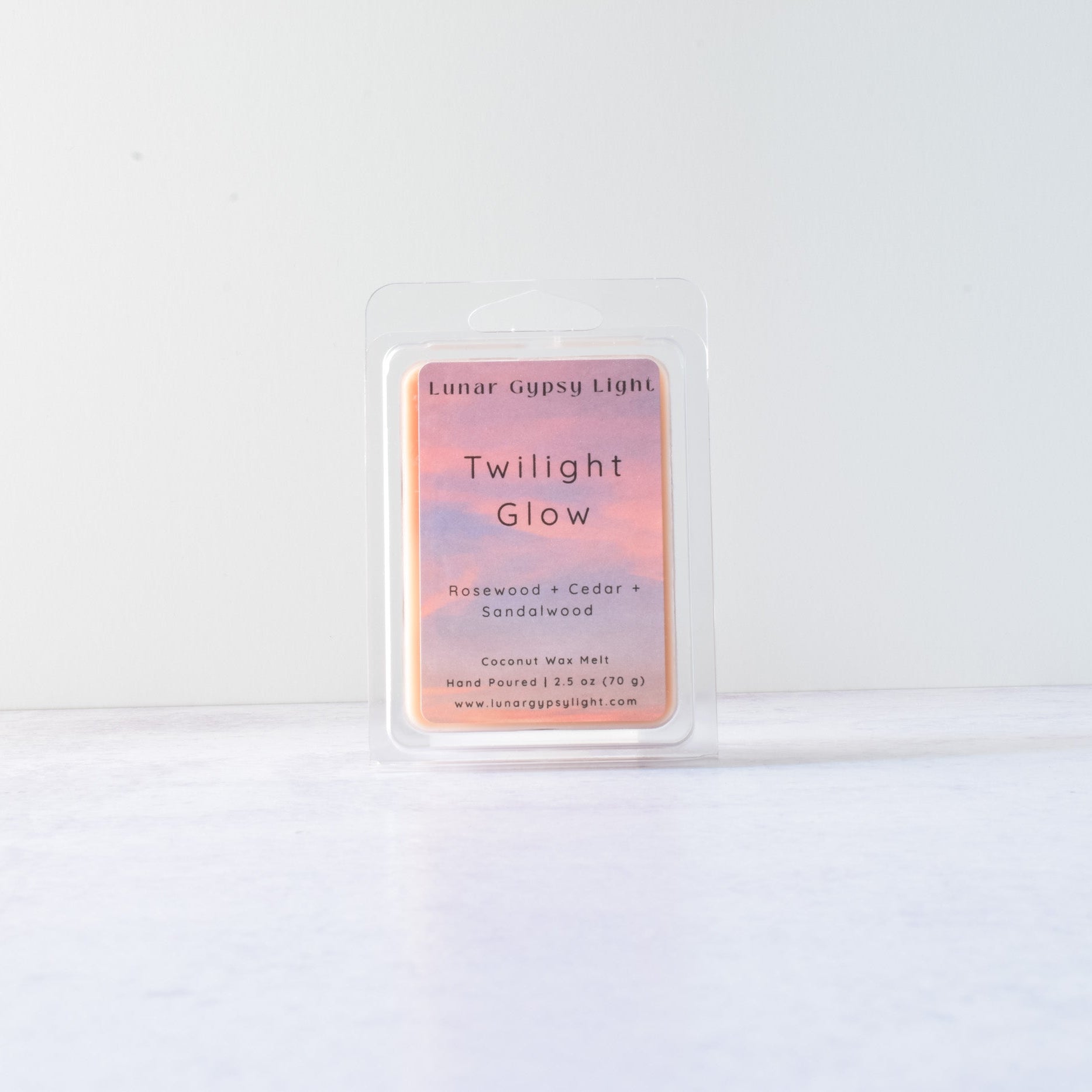 Wax melt with product packaging with 'Twilight Glow' on a white background