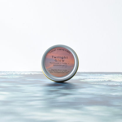 Candle Tin labeled 'Twilight Glow' on a fir inspired surface with a white background