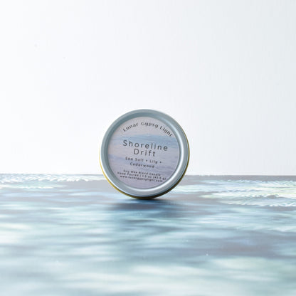 Candle Tin labeled 'Shoreline Drift' on a fir Inspired surface with a white background