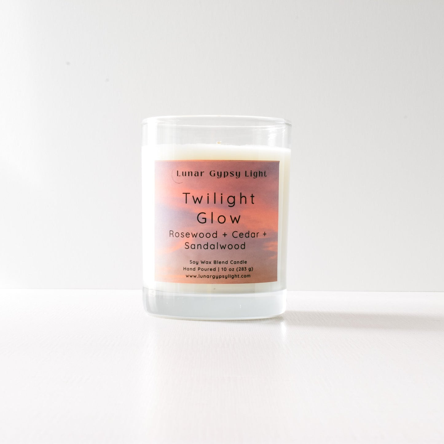 Candle labeled 'Twilight Glow' with a gradient label on a white background and gold lid