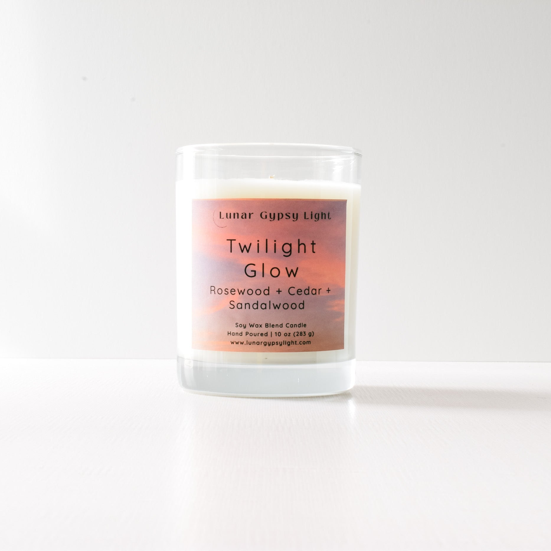 Candle labeled 'Twilight Glow' with a gradient label on a white background and gold lid