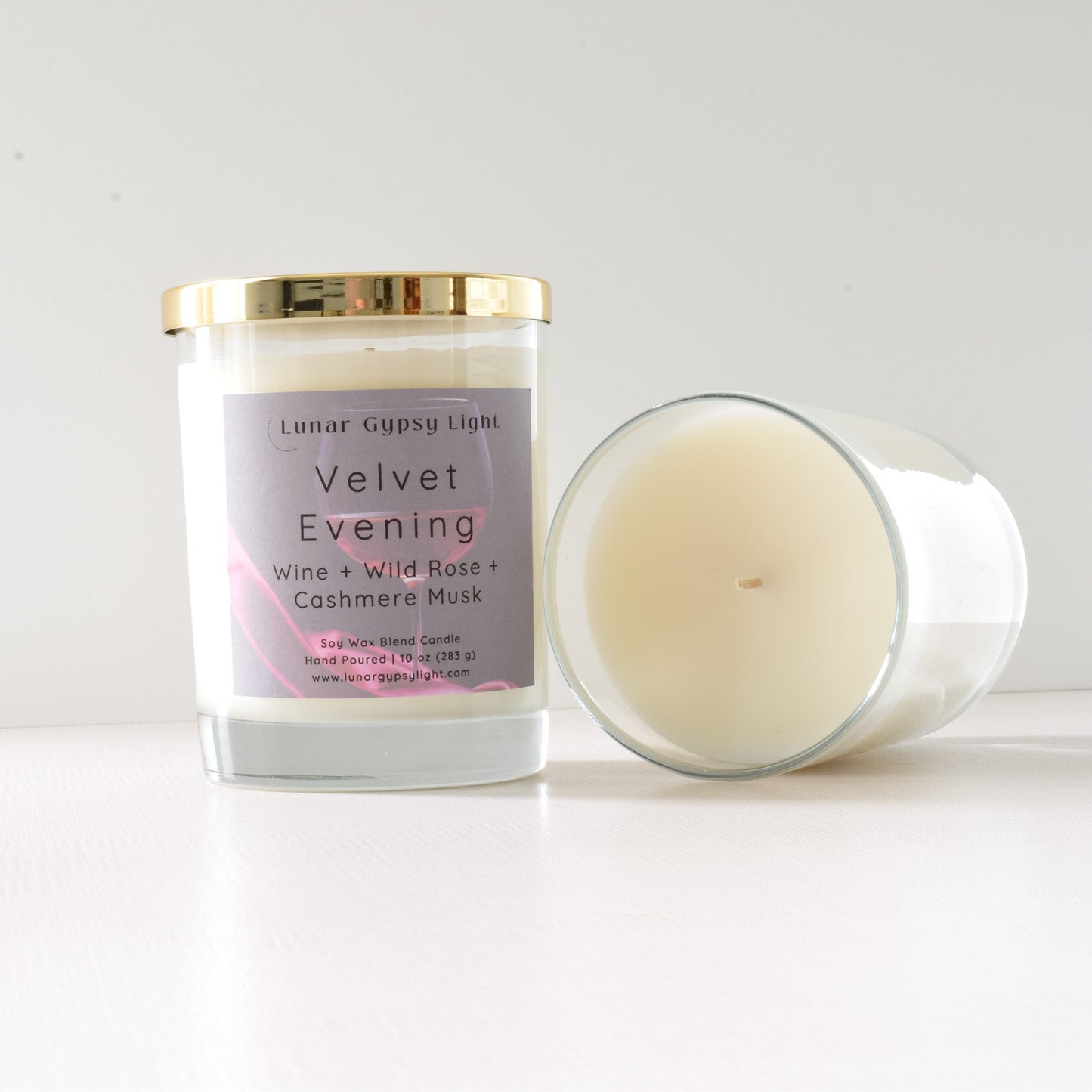 Candle with a label Velvet Evening  on a white background and gold lid