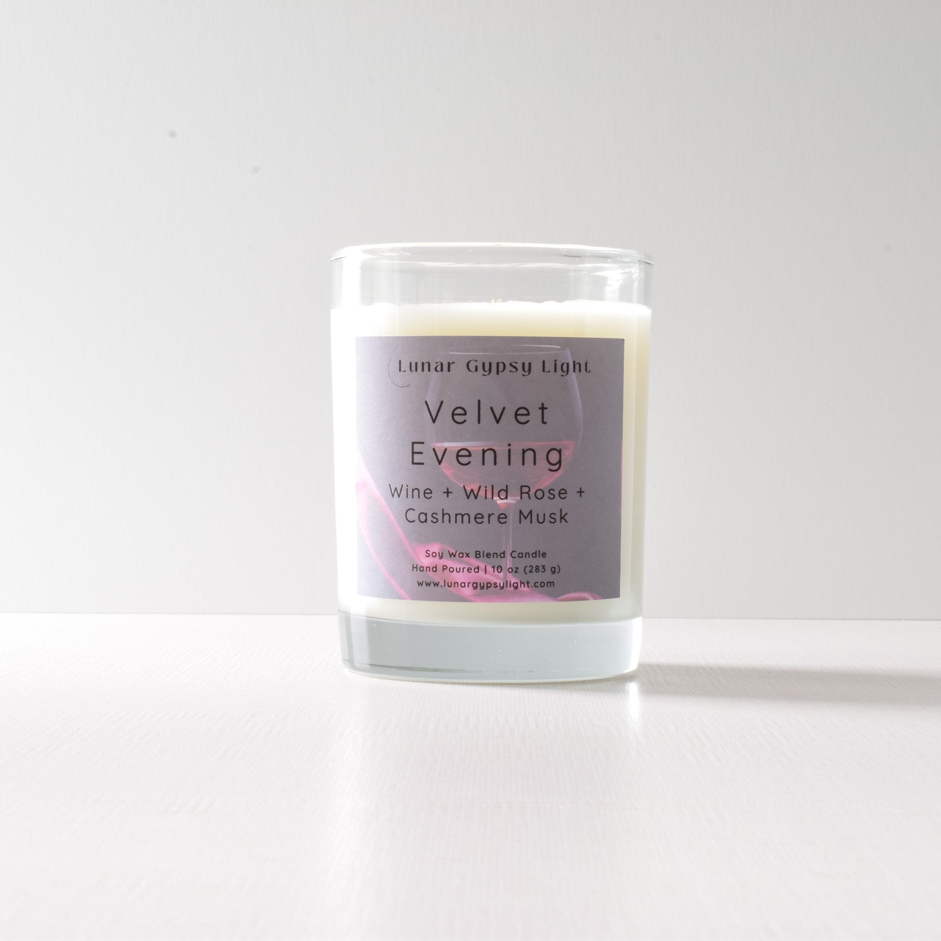 Candle labeled 'Velvet Evening' on a white background